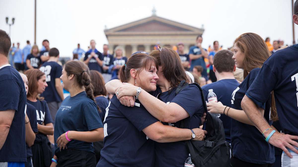  Friends and family members surrounded Cheryl Luxton (center) of Flourtown, Pa. at the Out of the Darkness walk to remember her son Cole, 15. (Lindsay Lazarski/WHYY)  