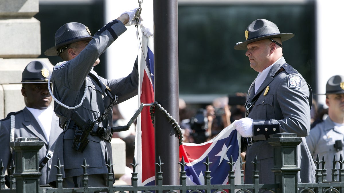  An honor guard from the South Carolina Highway patrol lowers the Confederate battle flag as it is removed from the Capitol grounds Friday, July 10, 2015, in Columbia, S.C. (AP Photo/John Bazemore) 