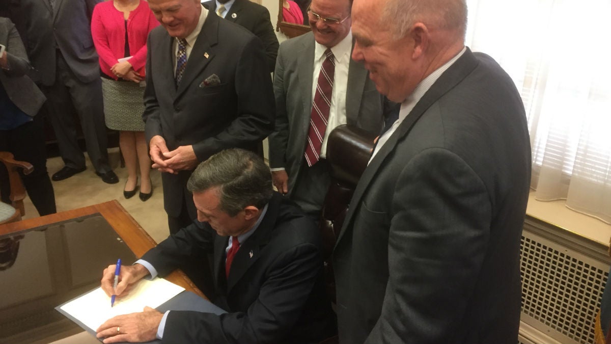 Gov. Carney signs his first executive order Wednesday afternoon at his office in Dover. (Zoe Read/WHYY)