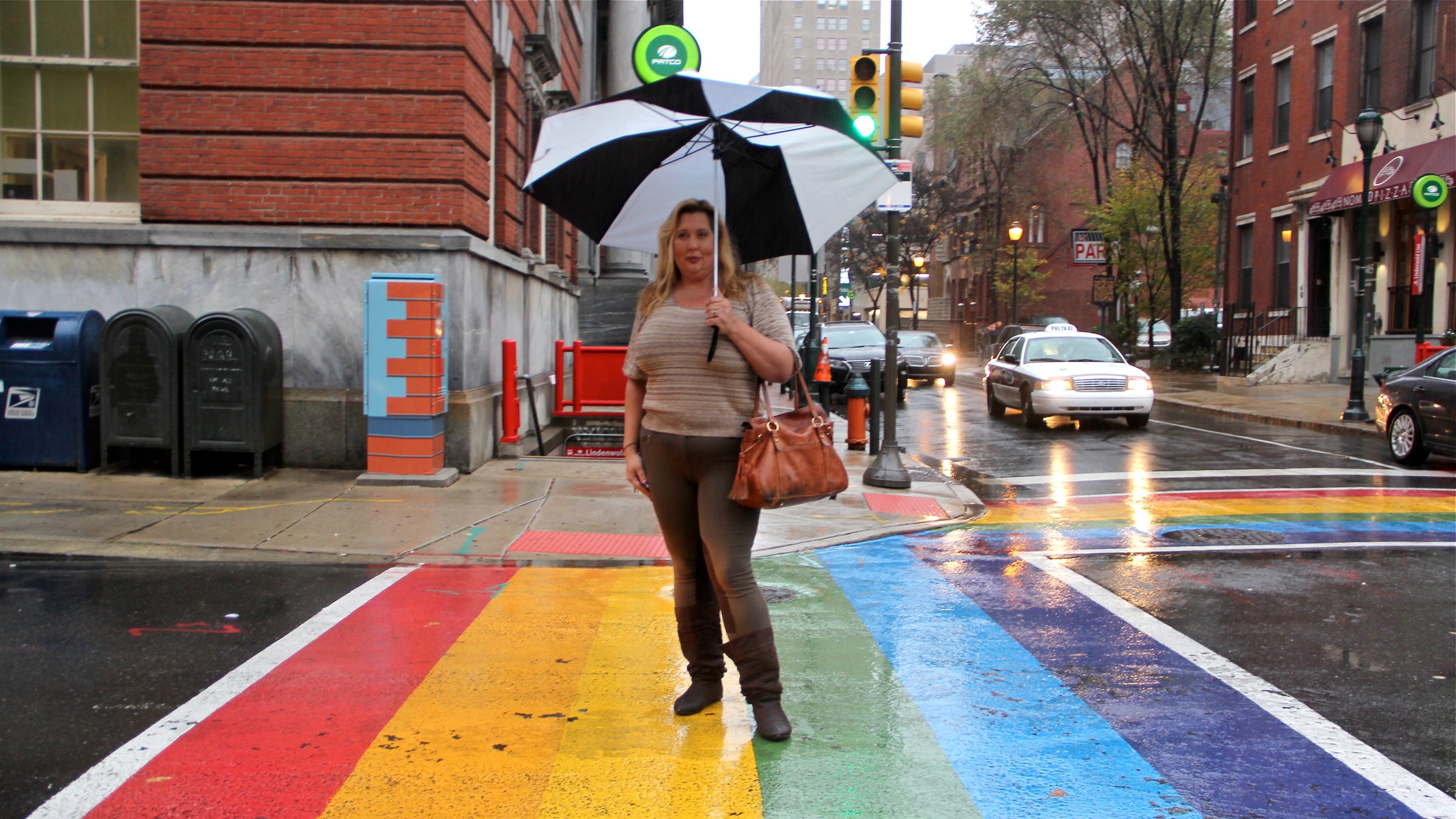 Deja Lynn Alvarez stands at the intersection of 13th and Locust streets