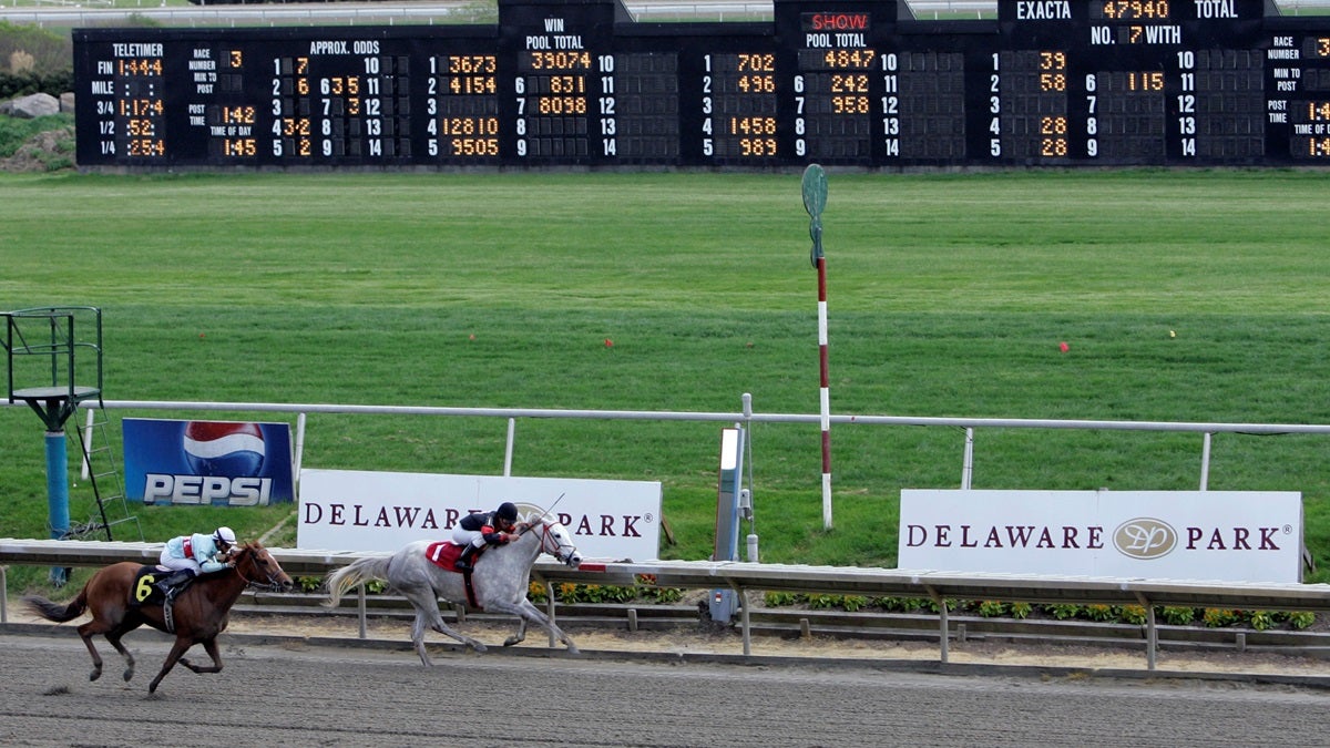  Horses cross the finish line at Delaware Park in Stanton, Del. (AP Photo/Rob Carr) 