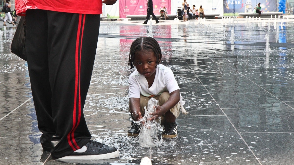 Anthony Dorsey, 4, enjoys the new splash fountains at Dilworth Park. (Kimberly Paynter/WHYY)