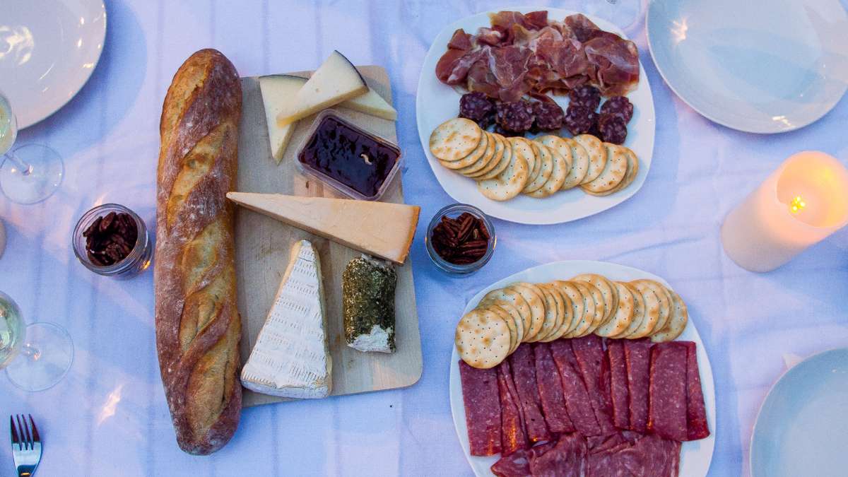  A baguette, cheeses and chacuterie sits on a table at Dîner en Blanc. (Brad Larrison/for NewsWorks) 
