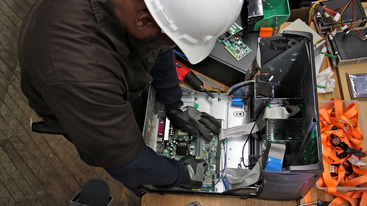 Floor manager Gerald quickly disassembles a desktop computer for recycling at Recycle Works. (Emma Lee/WHYY)