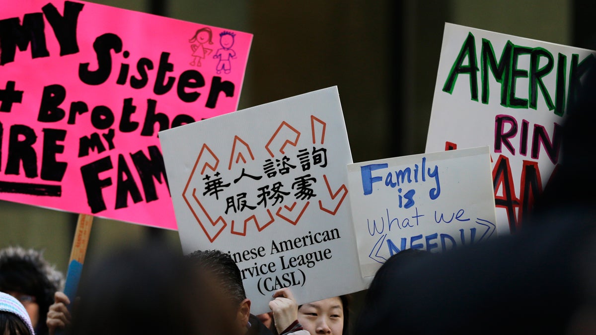 Immigrant rights protesters hold signs outside a Chicago federal building in March. Elected officials and leaders from the Asian