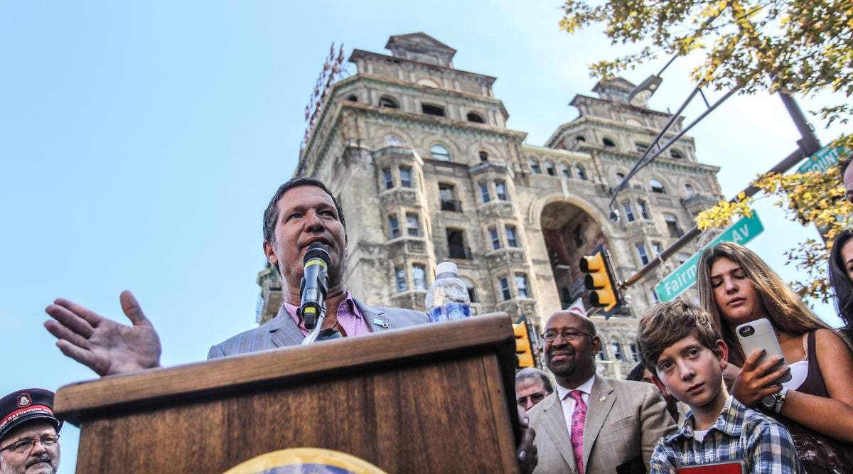 Eric Blumenfeld stands in front of the Divine Lorraine during its ground breaking ceremony Wednesday. (Kimberly Paynter/WHYY)