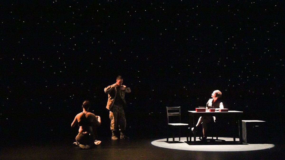  Actors Kate Czajkowski as Cressida,  Keith J. Conallen as Don Juan and Sarah Gliko as the curator share a scene in the Iraq desert in the play 'Don Juan Comes Home from Iraq,' at the Wilma Theater. (Kimberly Paynter/WHYY) 