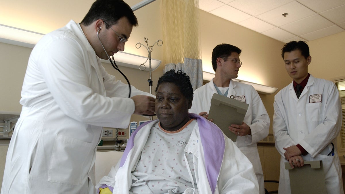 A physician performs a standard physical exam on a patient. (Credit: National Cancer Institute)