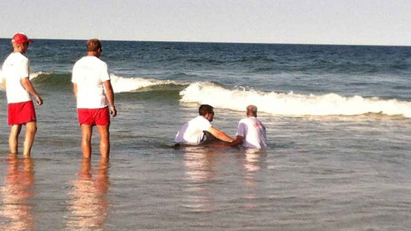  Lifeguards assisting a sick dolphin at Island Beach State Park late Sunday afternoon. (Photo: Sandy Bartkiewicz Rea via Facebook) 