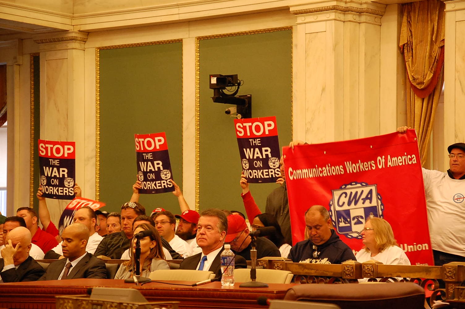 Verizon workers make their feelings known during Friday's City Council hearing. (Tom MacDonald/WHYY)