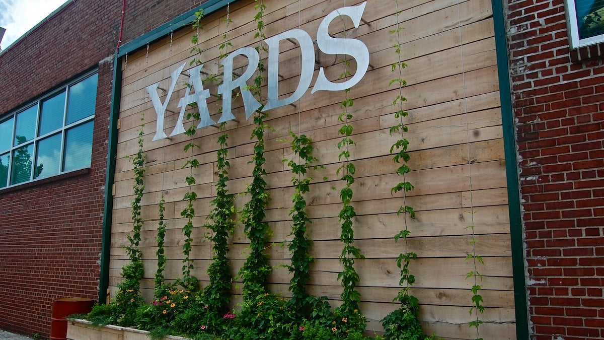  The wall, which dons a brand new Yards Brewery sign, is made of black locust, a native tree that grows along the banks of the Schuylkill and is currently growing three kinds of hops. (Emily Brooks/for NewsWorks) 