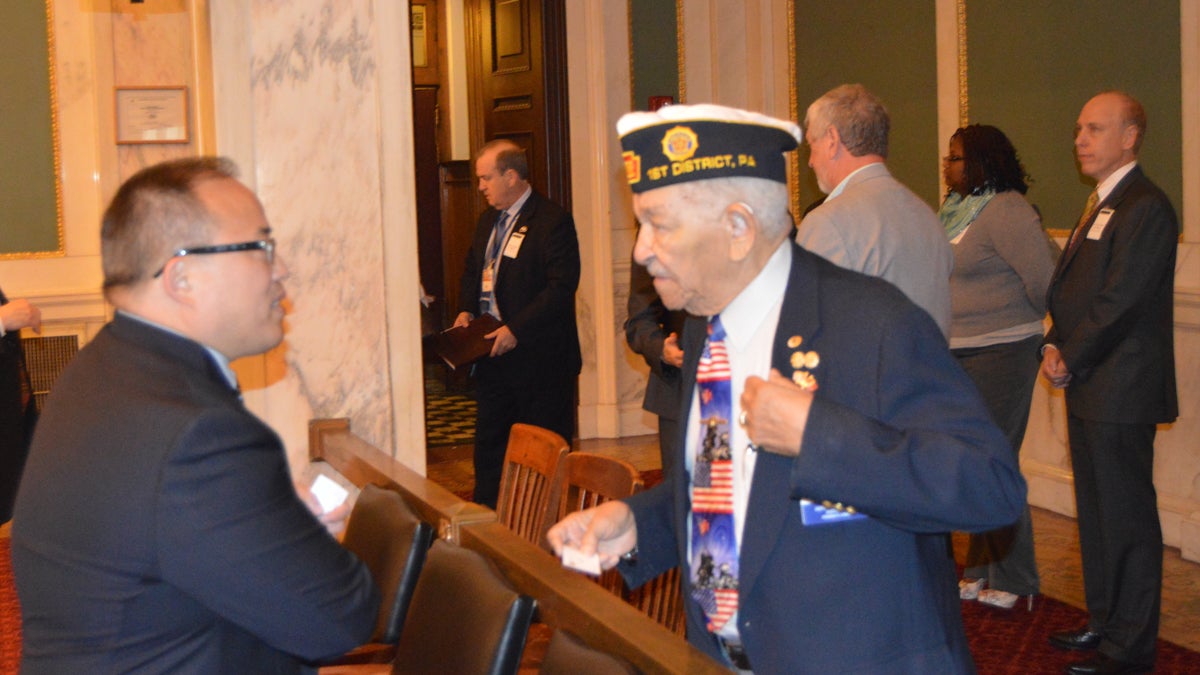  Philadelphia City Councilman David Oh talks with a veteran Monday. (Tom MacDonald/WHYY) 