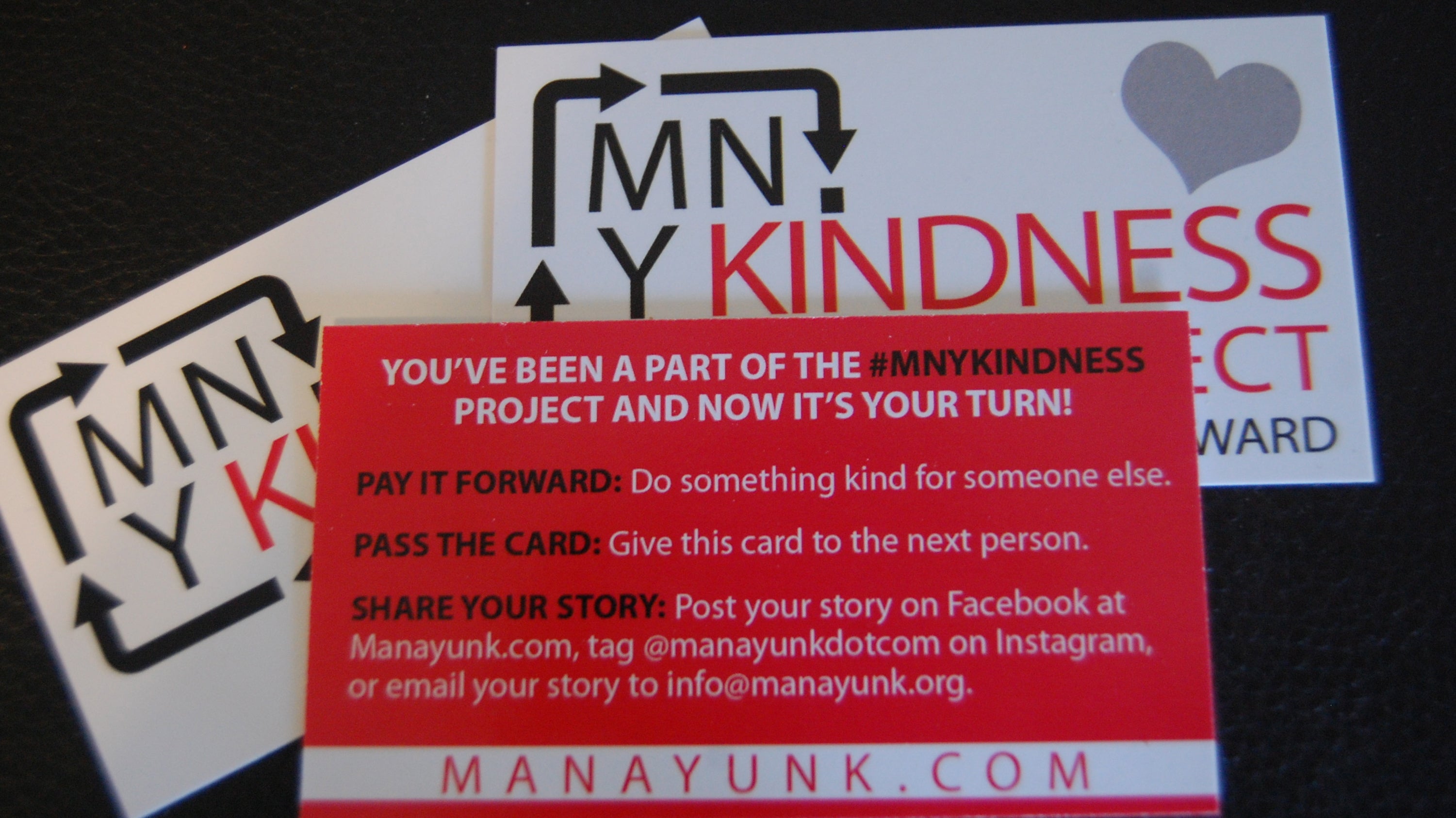  the Manayunk Development Corporation printed business-sized cards explaining the MNYKINDESS Project. (Emily Brooks/for NewsWorks) 