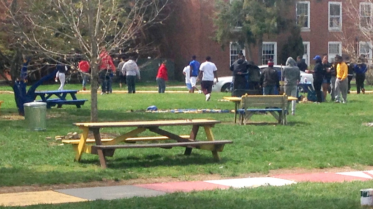  Students at Delaware State University disperse Sunday morning, April 19, 2015, after cleaning up the area where three people were shot and injured Saturday during a university-sanctioned cookout on campus in Dover, Del. Authorities are searching for the shooter. DSU President Harry L. Williams said students were told to stay inside their dormitories. Non-students were asked to leave campus. A second shooting occurred early Sunday at an apartment complex just off campus, but no one was injured. (AP Photo/Randall Chase) 