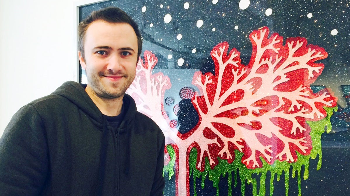 Artist Dylan Mortimer stands next to one of his artworks in the exhibition ‘Cure’ at Leedy-Voulkos Artr Center in Kansas City