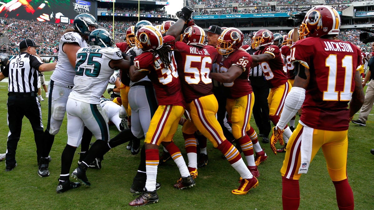  Officials try to break up a scuffle between the Washington and Philadelphia players during the second half of an NFL football game, Sunday, Sept. 21, 2014, in Philadelphia. (AP Photo/Matt Rourke) 