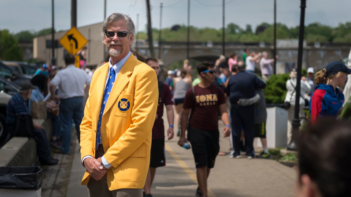 Braden J. Negaard poses in a yellow blazer that is presented to members of the Dad Vail Regatta community after a minimum ten years of involvement. Negaard has been involved with the Regatta for 43 years and is the second generation of his family to be part of the event. (Branden Eastwood for NewsWorks)