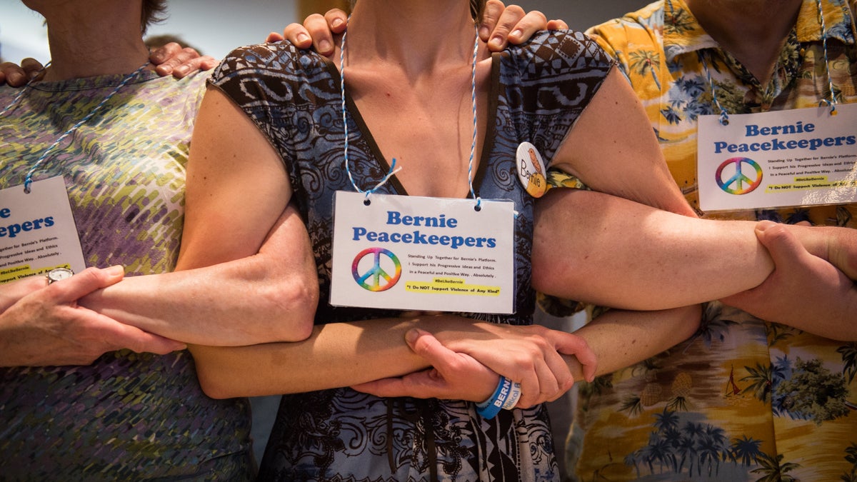 Bernie Peace Keepers link arms during a class on diffusing tension during protests in preparation for the Democratic National Convention. (Branden Eastwood For NewsWorks)