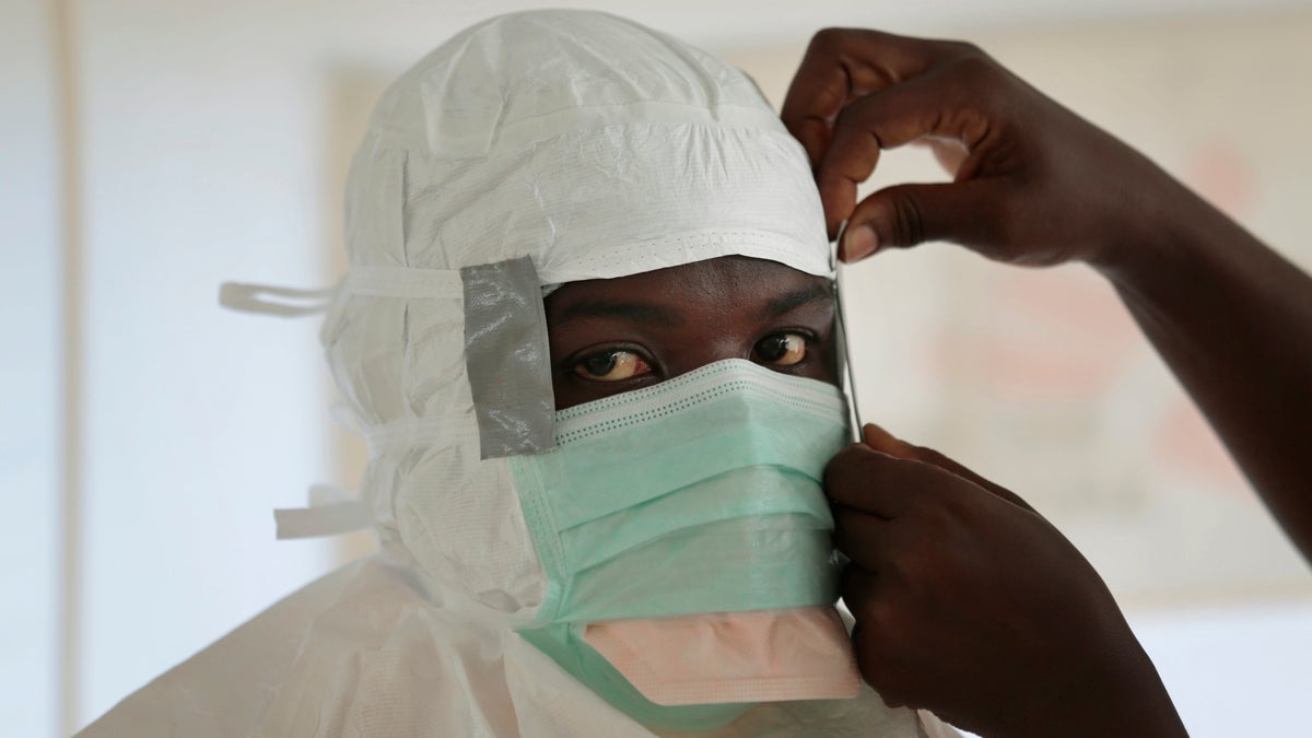 An MSF (Medecins Sans Frontieres) nurse gets prepared with Personal Protection Equipment before entering a high risk zone of MSF's Ebola isolation and treatment centre in Monrovia