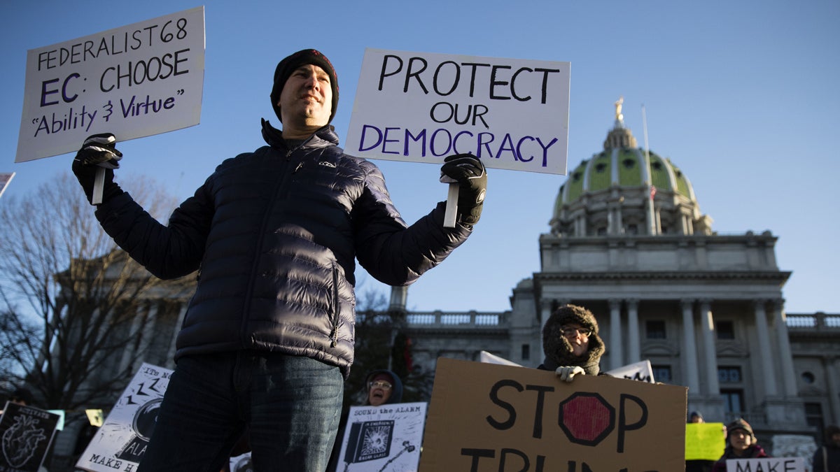 Protesters demonstrate ahead of Pennsylvania's 58th Electoral College at the Capitol in Harrisburg