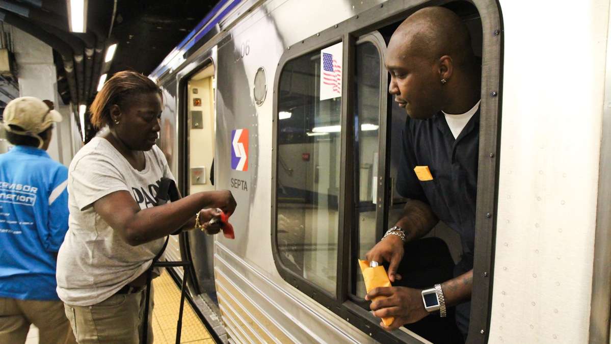  Train operator Maurice Bey collects fares at the front of the train for Nite Owl service (Kimberly Paynter/WHYY) 