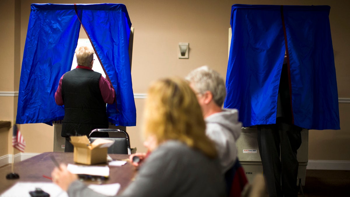  A voter steps into voting booth at the Oregon New Years Association in Philadelphia. An analysis of Department of State data shows turnout in Pennsylvania's struggling communities in 2010 was down nearly 20 percent from 1994. (AP Photo/Matt Rourke) 