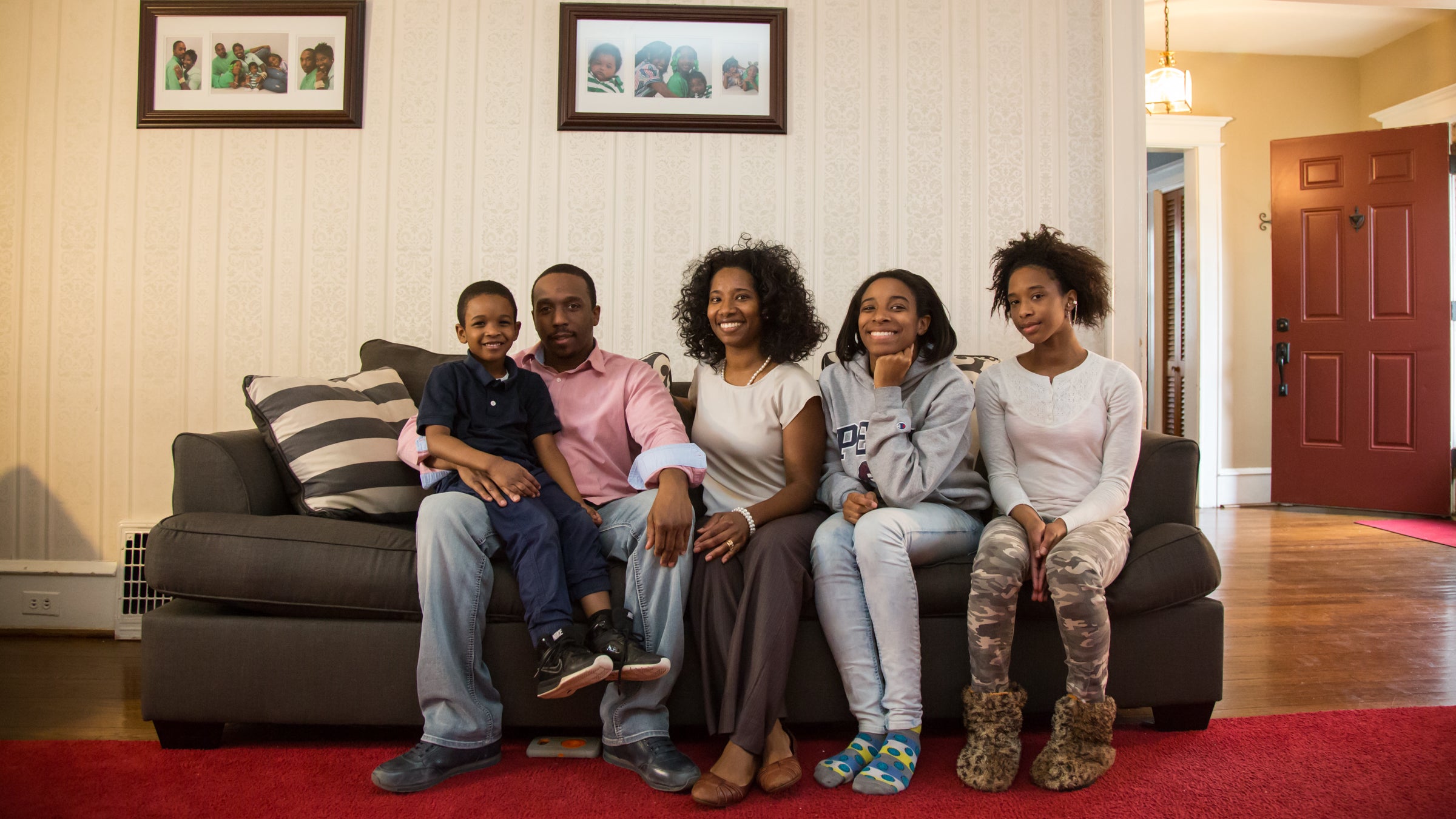 The Miller family sits in the living room of their Landsdowne home in 2016. (Emily Cohen for WHYY)