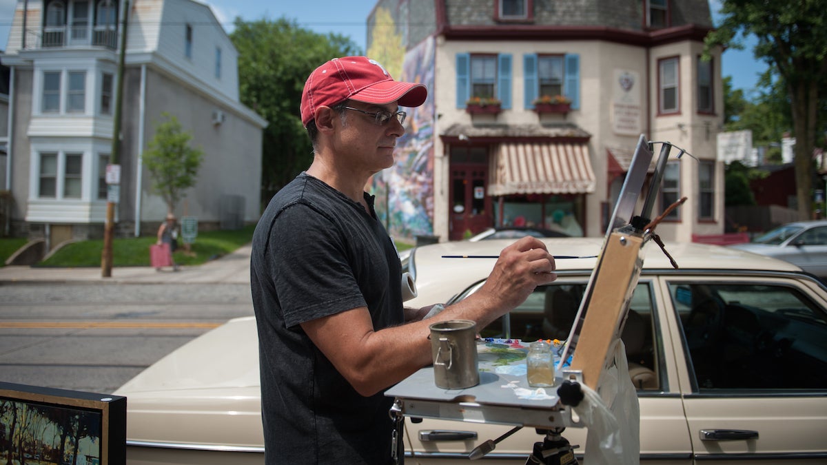 Matt Deprospero, of South Philadelphia, paints the Laurel Hill Gardens on Germantown Avenue during Chestnut Hills' Plein Air event Sunday morning, June 14, 2015. Artists from throughout the region set up outdoors along the avenue to paint the scenes surrounding them.