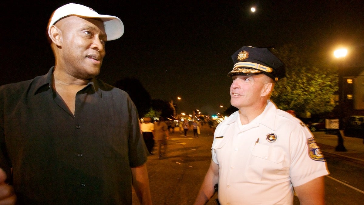  State Rep. Dwight Evans and Police Inspector James Kelly walk along Ogontz Avenue at the West Oak Lane Night Market in June. (Bas Slabbers/for NewsWorks, file) 