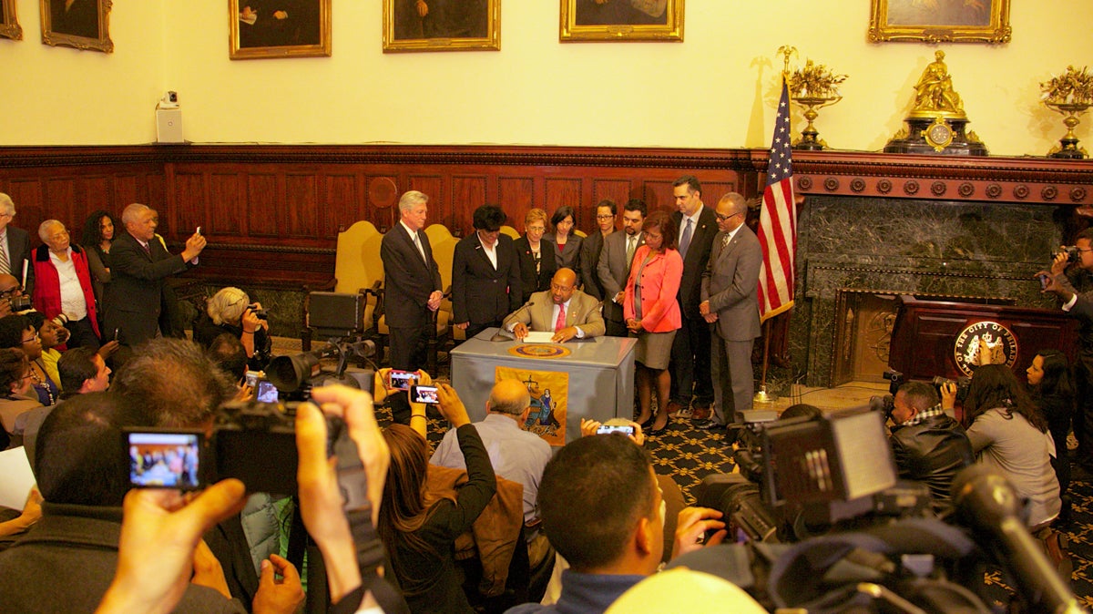  Mayor Nutter reading the executive order that ends ICE detainers as long as the person being released has no first or second degree felonies. (Nathaniel Hamilton/For Newsworks) 