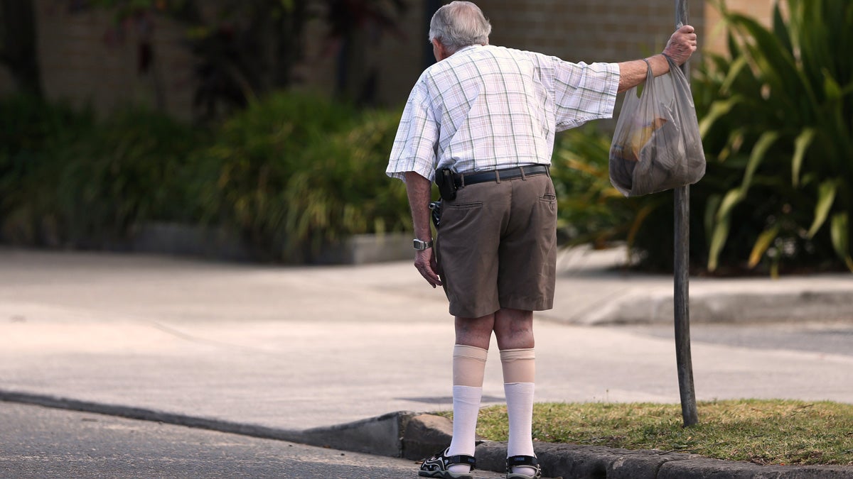  In this Oct. 11, 2013 photo, an elderly man holds onto a signpost on the side of a road in Sydney. About a third of people over 65 fall every year, according to the World Health Organization. (AP Photo/Rick Rycroft, File) 