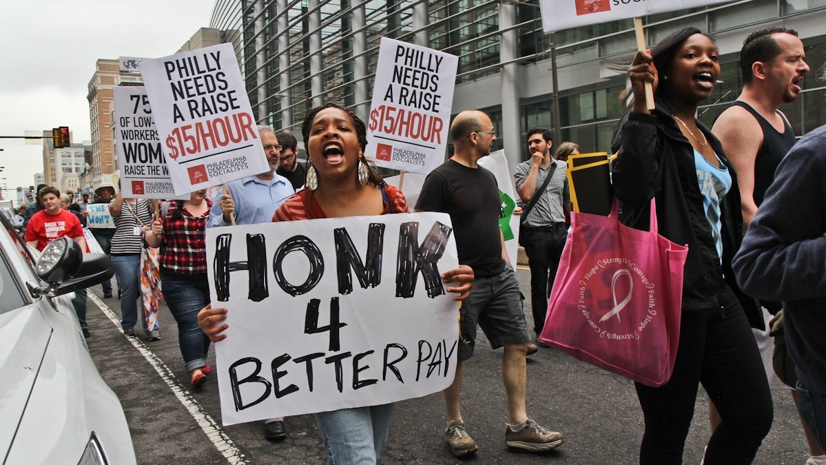  Philadelphia fast food workers and supporters march down Broad Street to demand a pay raise to $15 an hour. (Kimberly Paynter/WHYY) 