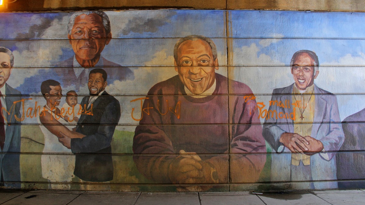  Philadelphia's Mural Arts Program has stepped up its plans to remove the damaged Father's Day mural on Broad Street in North Philadelphia. Bill Cosby figures prominently in the work.(Emma Lee/WHYY) 