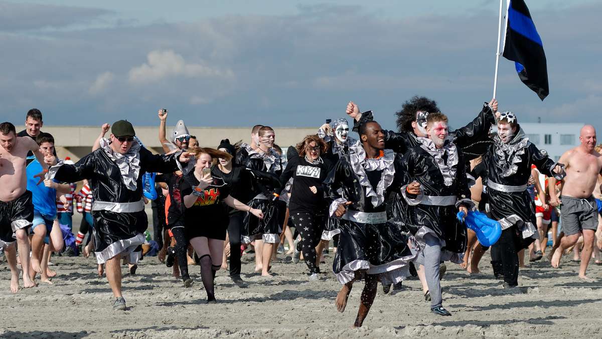 The PiggyPark Plungers run towards the ocean during the Plunge on Jan 16, 2016. (Bastiaan Slabbers for NewsWorks)