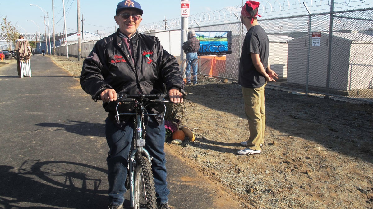  Port Richmond resident Frank Stypulkowski rides his bike on the new trail along the Delaware River waterfront. The Port Richmond Trail is a key link in the Circuit, a network of trails in New Jersey and Pennsylvania (Katie Colaneri/WHYY). 