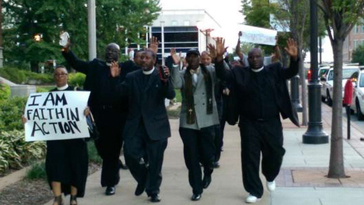  The Rev. Mark Tyler from Mother Bethel AME and other clergy members march in support of and pray for peace in Ferguson. (Image courtesy of POWER)  