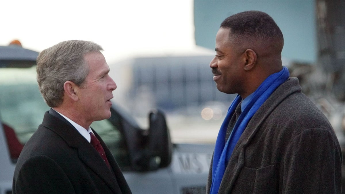  President George W. Bush, left, shakes hands with Garry Cobb, former Philadelphia Eagles player, on Thursday, Dec. 12, 2002 during his arrival at Philadelphia International Airport. (AP Photo/Pablo Martinez Monsivais, file) 