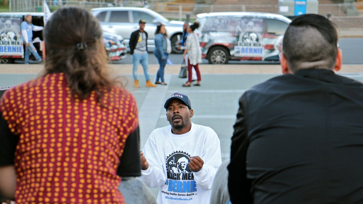 Gary Frazier of  Black Men for Bernie speaks to Bernie Sanders supporters during a meeting on the steps of the Philadelphia Museum of Art. (Emma Lee/WHYY)