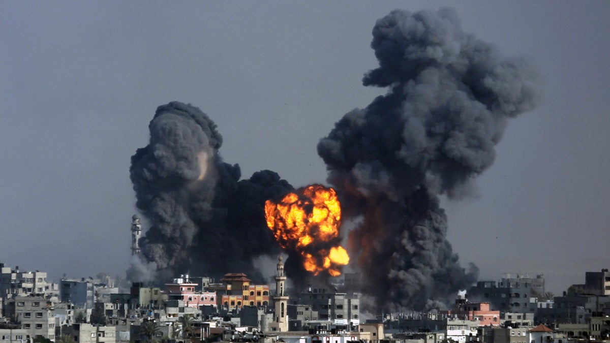  Smoke and fire from the explosion of an Israeli strike rise over Gaza City on Tuesday. Disagreement over whether to lift the Gaza blockade is a key stumbling block to ending more than two weeks of fighting between the Islamic militant Hamas and Israel. (AP Photo/Hatem Moussa) 