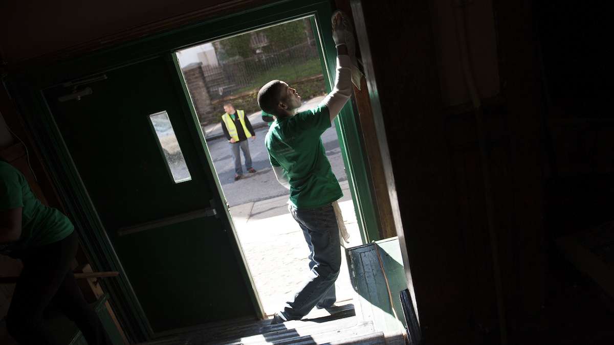  Volunteers cleaning up the Germantown Boys and Girls club last year. (Tracie Van Auken/for NewsWorks, file) 