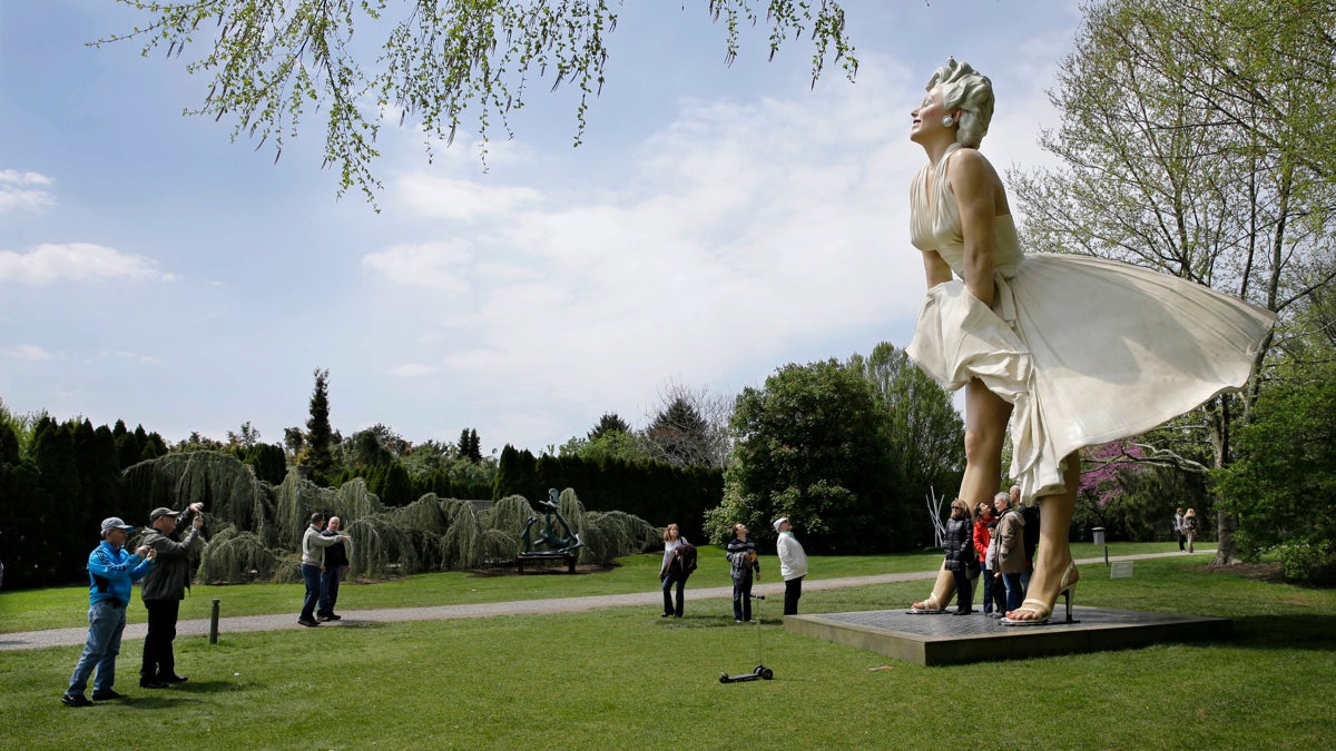  People have their photos taken with a larger-than-life sculpture of Marilyn Monroe at the Grounds for Sculpture in Hamilton, N.J. (Mel Evans/AP Photo) 
