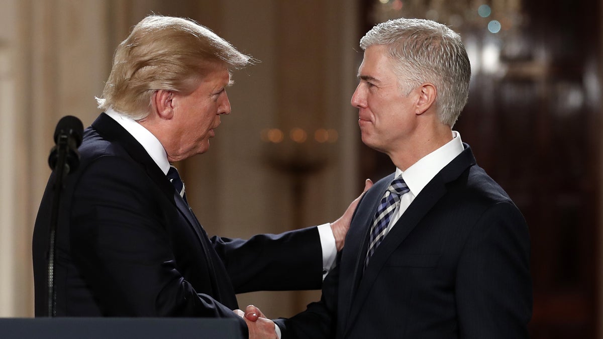  President Donald Trump watches as Supreme Court Justice Anthony Kennedy administers the judicial oath to Judge Neil Gorsuch during a re-enactment in the Rose Garden of the White House White House in Washington, Monday, April 10, 2017. (AP Photo/Evan Vucci) 