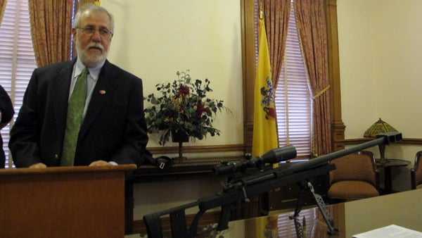  Brian Miller, with the gun violence prevention group Heeding God's Call, displays a disabled 50-caliber rifle at a Statehouse news conference Friday. (Phil Gregory/for NewsWorks) 