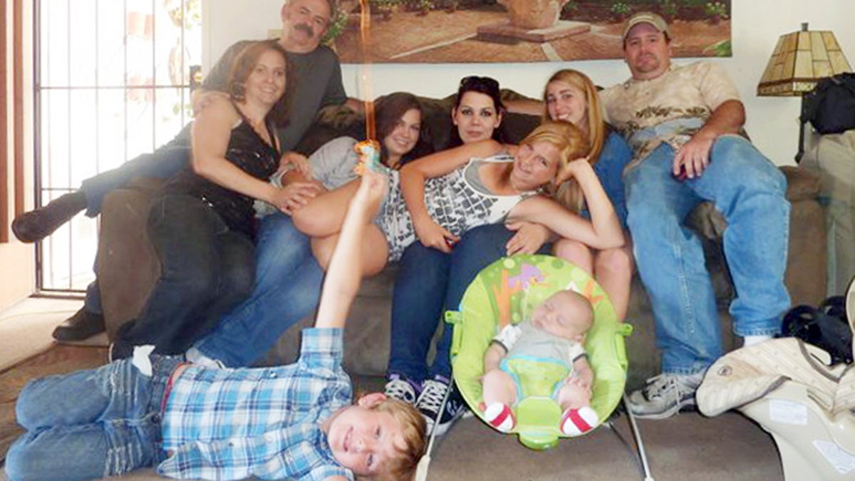  Members of the extended Anderson and Saincome families, seated from left are Christina Anderson, Christopher Saincome, Christina's sisters Samantha Saincome and Andrea Saincome, their niece Hannah Anderson, (reclining), Alexi (last name unavailable, friend of Hannah's), and James Lee DiMaggio. On the floor are Ethan Anderson, left, and Andrea's infant child, whose name was not released. (AP Photo/Andrea Saincome) 