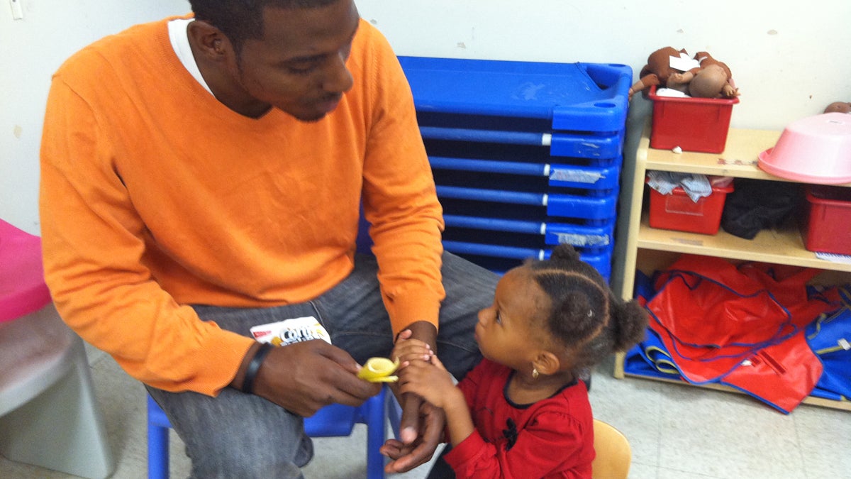  Marcus Tuggles with daughter Kailani, 2, sees cuts to Head Start programs as tragic.  (Elana Gordon/WHYY)  