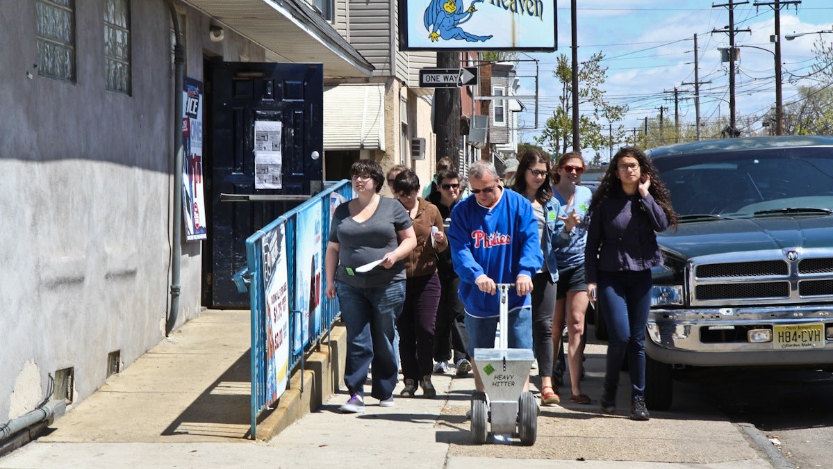  Environmentalists participate in HighWaterLine, a project by artist Eve Mosher which draws an estimated flood line in chalk through Philadelphia from Richmond and Castor Avenue to Penn Treaty Park. (Kimberly Paynter/WHYY) 