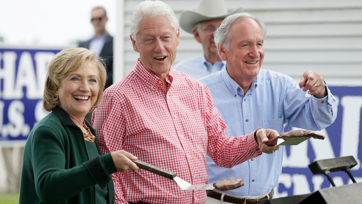  Former Sec. of State Hillary Rodham Clinton, former President Bill Clinton and U.S. Sen. Tom Harkin work the grill during Harkin's annual fundraising Steak Fry Sunday, in Indianola, Iowa. (AP Photo/Charlie Neibergall) 