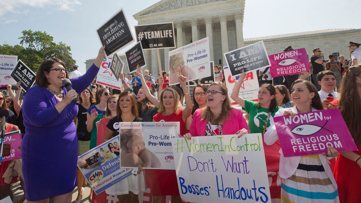  Kristin Hughs, left, is shown announcing to supporters the Supreme Court's decision on the Hobby Lobby case in Washington, on Monday, June 30, 2014. (AP Photo/Pablo Martinez Monsivais) 