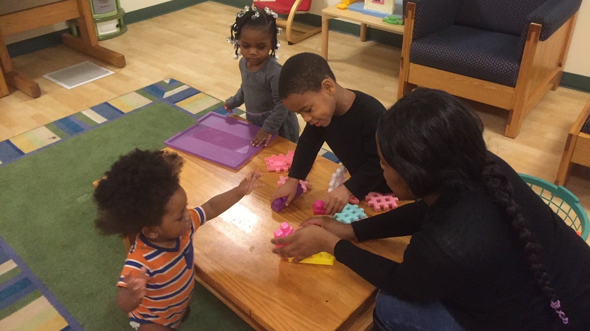  Sasha and her children, 4-year-old Lamere, 2-yera-old Serenity, and 1-year-old Sincere, play at a homeless shelter. (Zoe Read/WHYY) 