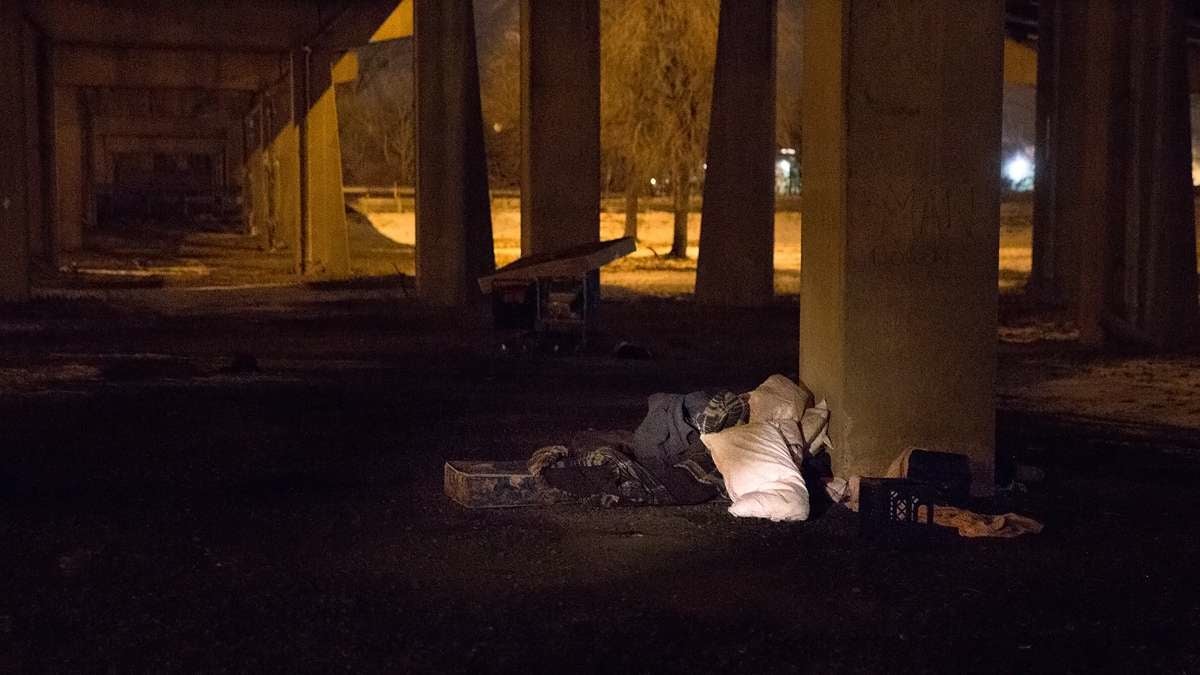 An empty bed is found underneath an overpass near the Walt Whitman Bridge. (Lindsay Lazarski/WHYY)